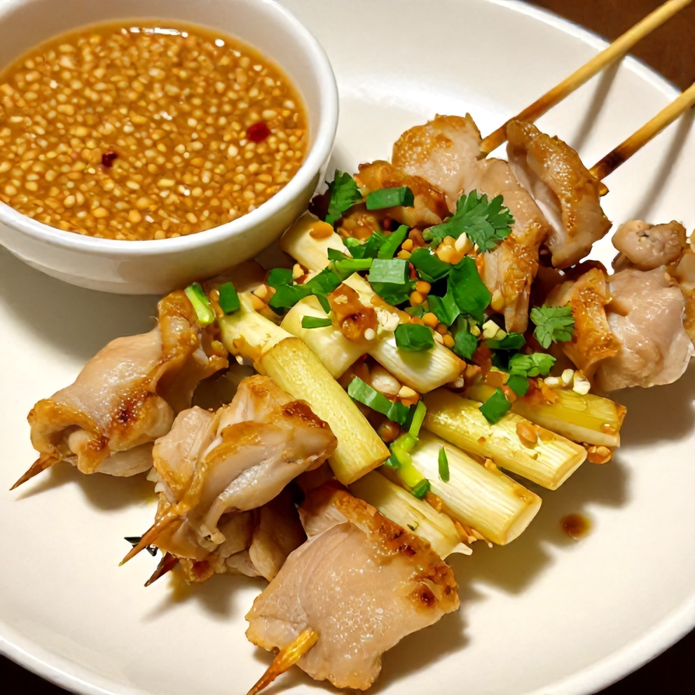Plated Vietnamese lemongrass chicken skewers with peanut sauce