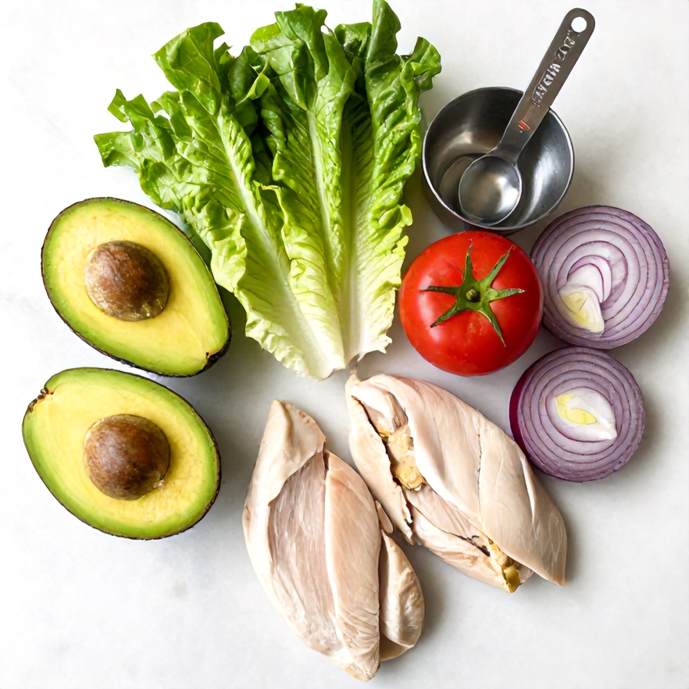 Raw ingredients for Quick Chicken Avocado Wrap on a marble surface