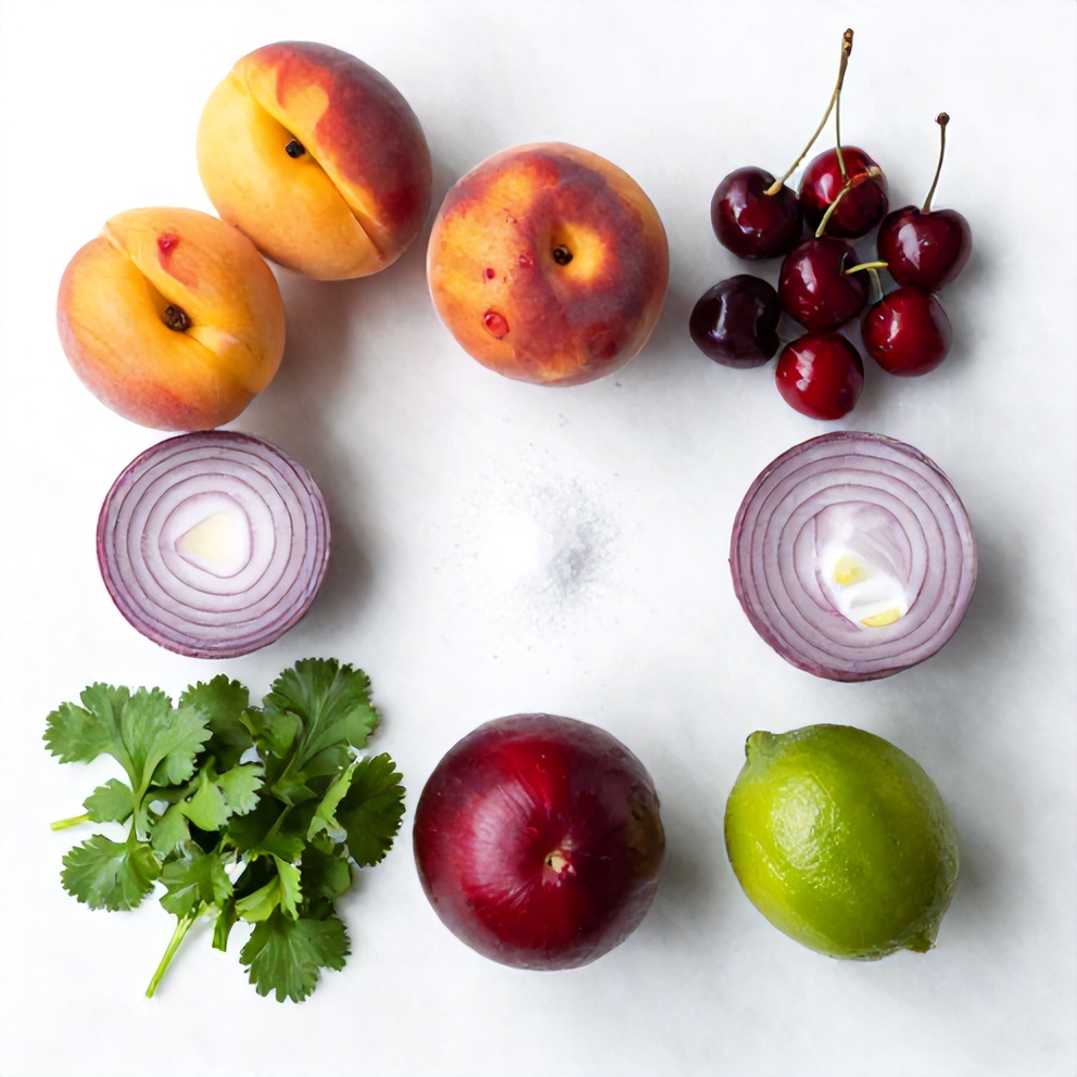Raw ingredients for Healthy Peach Cherry Salsa arranged in an overhead flat lay on a white marble surface under bright even light, including ripe peaches, fresh cherries, red onion, jalapeño, cilantro, lime, and salt.
