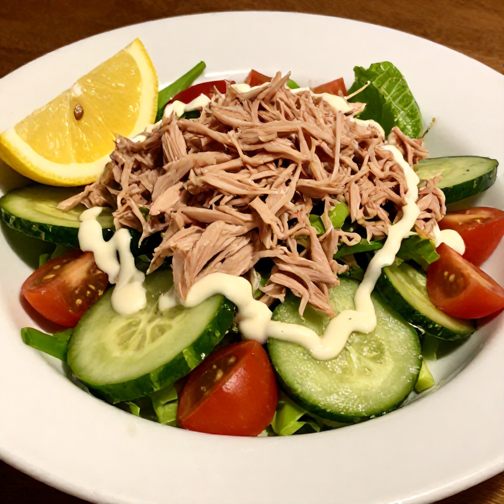 Plated Mediterranean tuna salad with lemon wedge